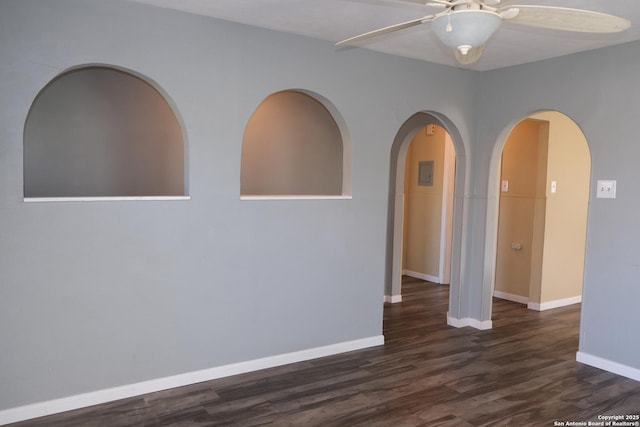 empty room with dark hardwood / wood-style floors and ceiling fan