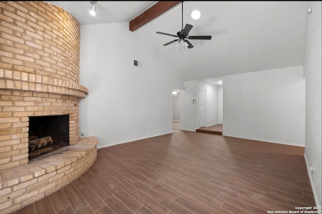 unfurnished living room with a fireplace, lofted ceiling with beams, and ceiling fan