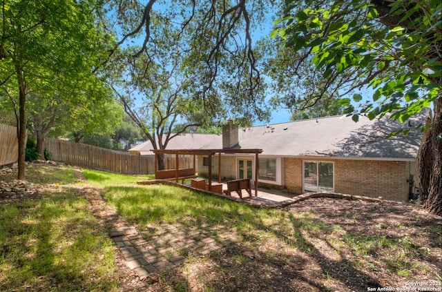 back of property featuring a patio area and a yard