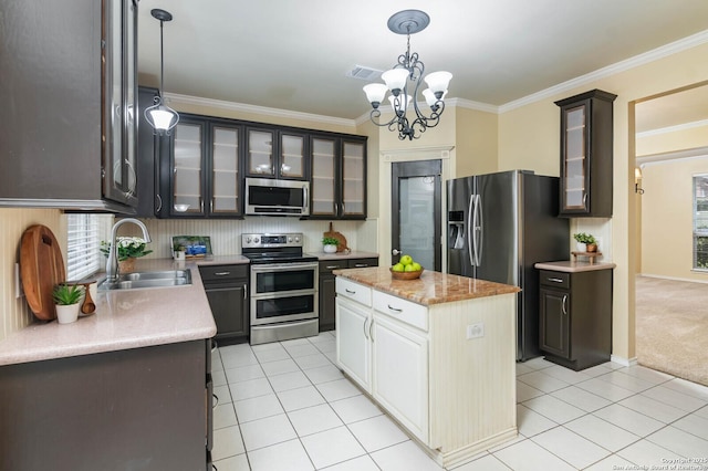 kitchen featuring an inviting chandelier, hanging light fixtures, sink, appliances with stainless steel finishes, and white cabinetry