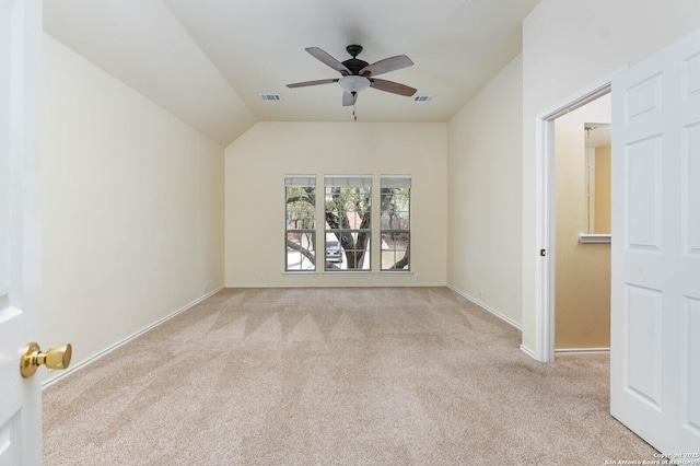 unfurnished room with light carpet, ceiling fan, and vaulted ceiling