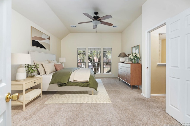 bedroom with light carpet, access to exterior, vaulted ceiling, and ceiling fan