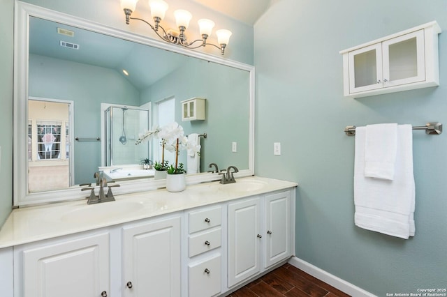 bathroom with vanity, vaulted ceiling, and an enclosed shower