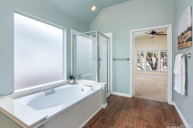 bathroom featuring ceiling fan, lofted ceiling, and independent shower and bath