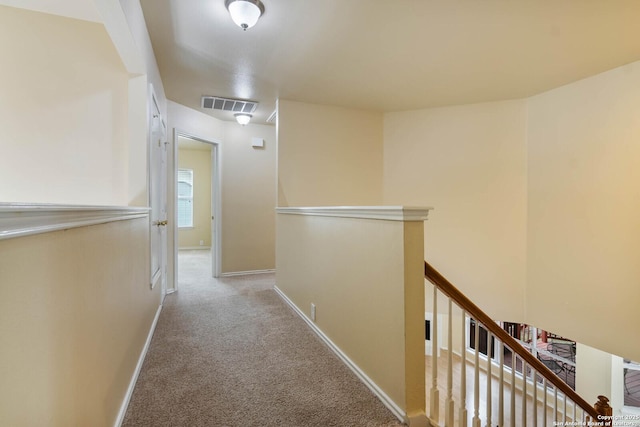 hallway featuring light carpet