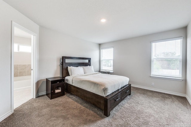 carpeted bedroom with connected bathroom