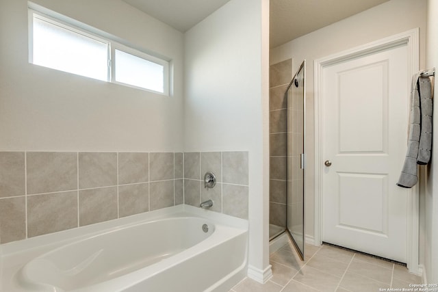 bathroom with tile patterned floors and independent shower and bath