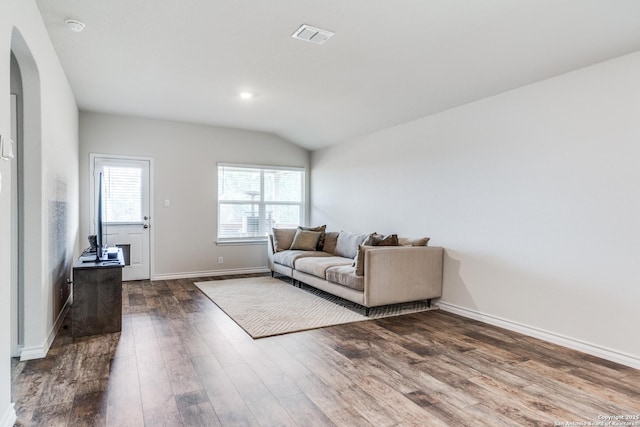 living room with vaulted ceiling and dark wood-type flooring