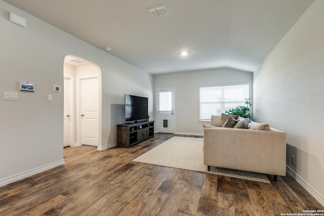 living room with vaulted ceiling and hardwood / wood-style flooring