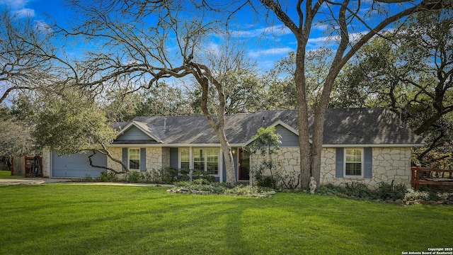 ranch-style home featuring a front yard and a garage