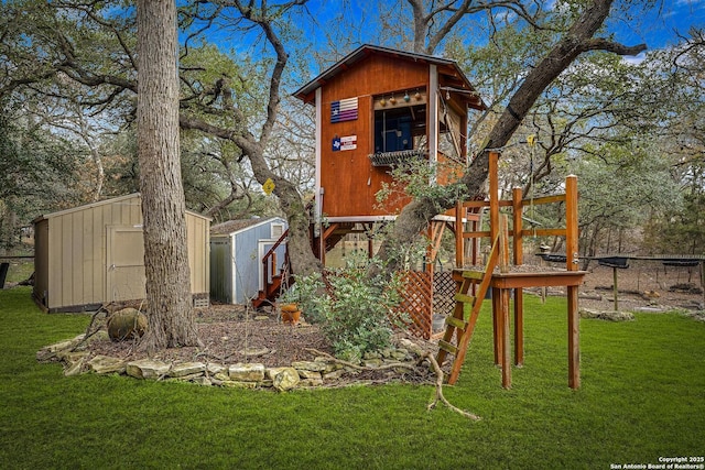 exterior space featuring a lawn and a storage shed