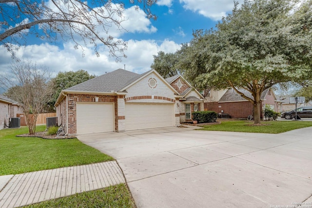 view of front of property with a garage, a front yard, and central AC unit