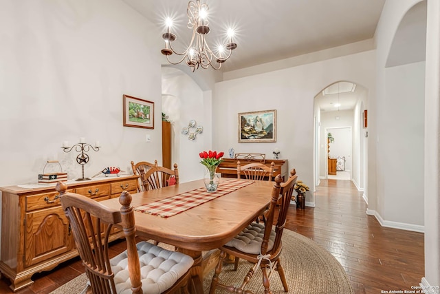 dining area with dark hardwood / wood-style flooring and a chandelier