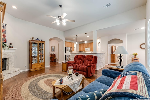 living room with hardwood / wood-style flooring, a fireplace, and ceiling fan