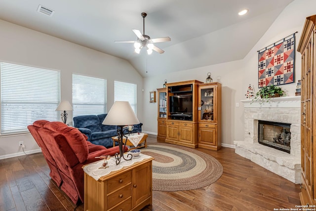 living room with dark hardwood / wood-style flooring, a fireplace, and plenty of natural light