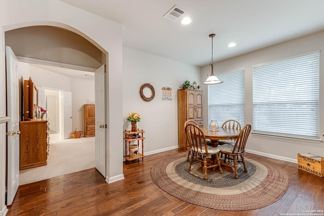 dining space with dark hardwood / wood-style floors