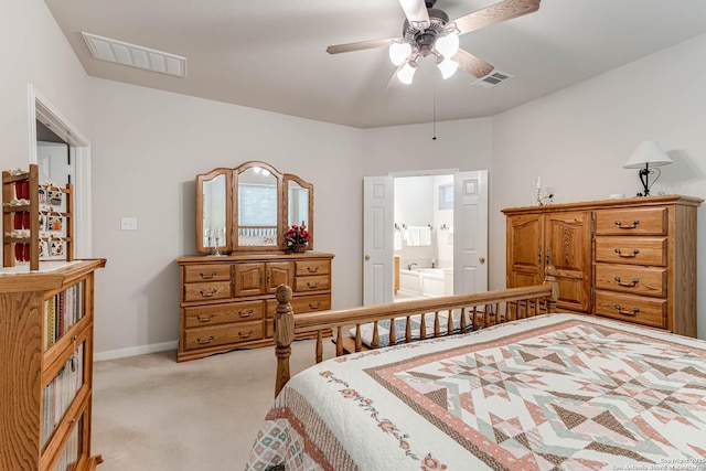 bedroom with ceiling fan, ensuite bath, and light colored carpet