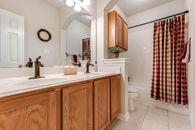 full bathroom with shower / tub combo with curtain, vanity, tile patterned floors, and toilet