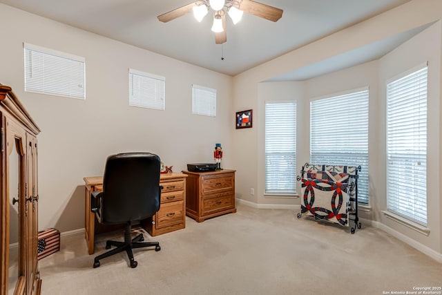 home office featuring light carpet and ceiling fan