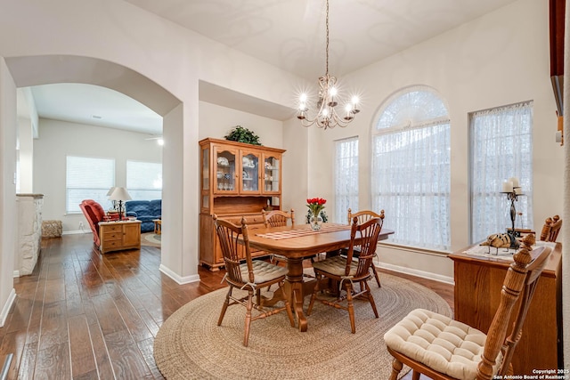 dining area featuring dark hardwood / wood-style floors and a chandelier