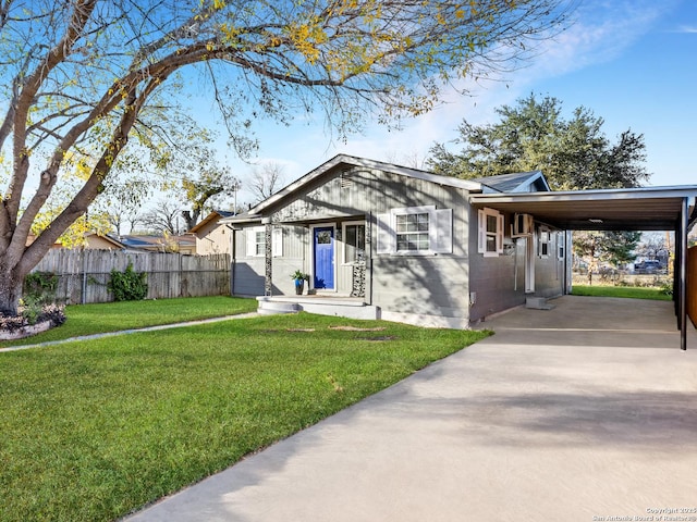 view of front of home with a front lawn and a carport