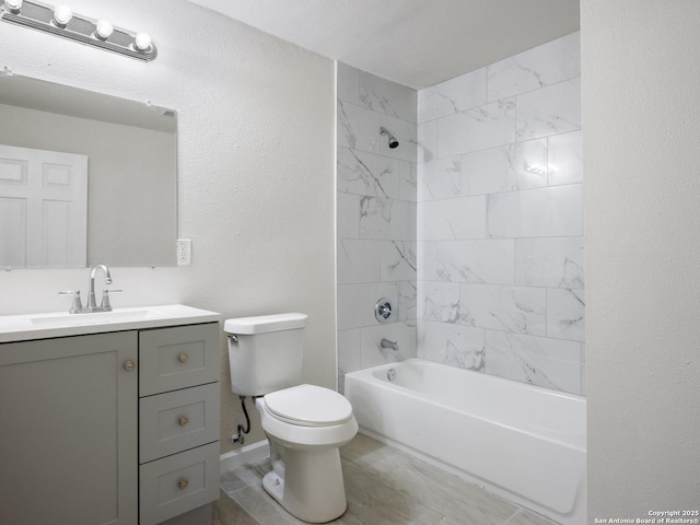 full bathroom with vanity, toilet, and tiled shower / bath