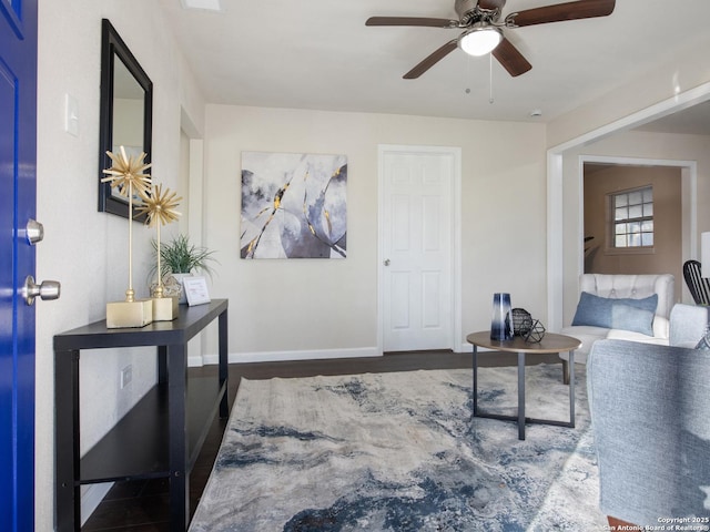 living room featuring ceiling fan and dark hardwood / wood-style floors