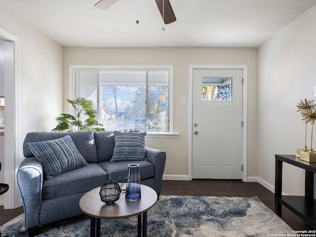 living room with ceiling fan and dark hardwood / wood-style flooring