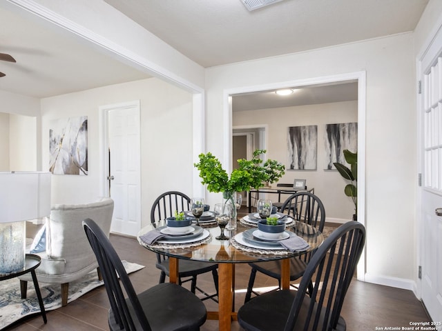 dining space with dark hardwood / wood-style floors