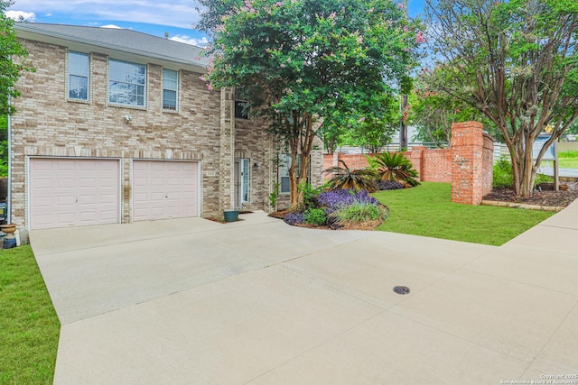 view of front of house featuring a garage and a front lawn