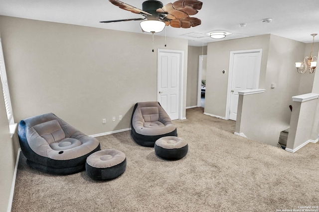 living area with carpet flooring and ceiling fan with notable chandelier