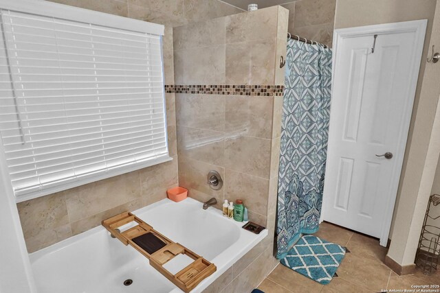 bathroom featuring tile patterned floors and separate shower and tub