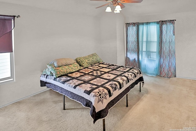 bedroom with ceiling fan and light carpet