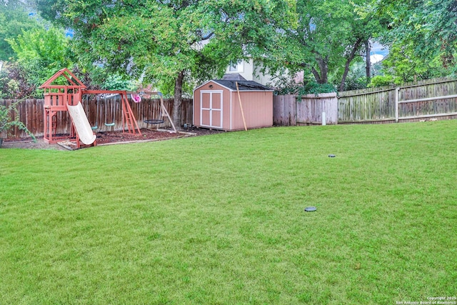 view of yard with a playground and a storage unit