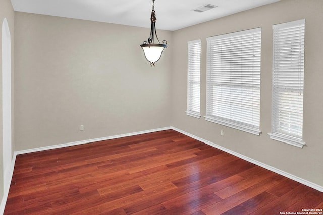 empty room with dark hardwood / wood-style floors