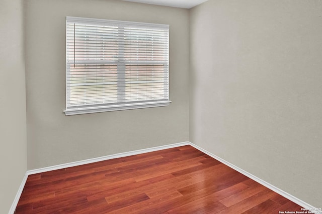 unfurnished room with hardwood / wood-style flooring