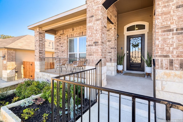 view of exterior entry with covered porch