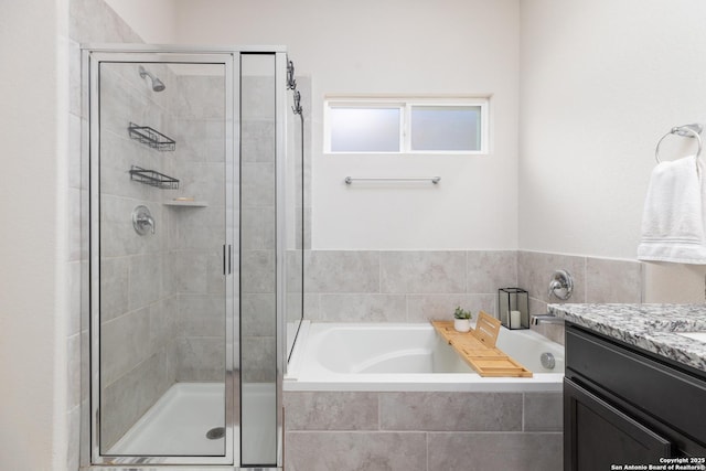 bathroom featuring vanity and shower with separate bathtub