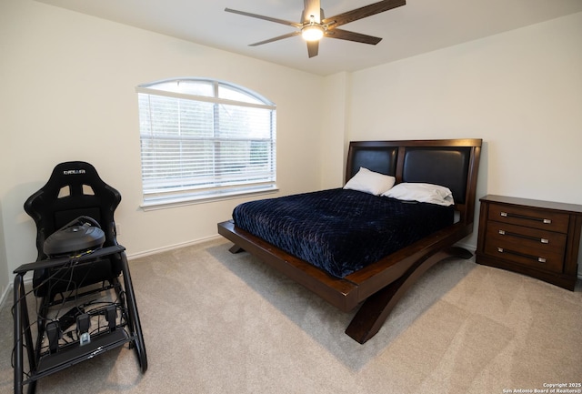 bedroom featuring ceiling fan and light carpet