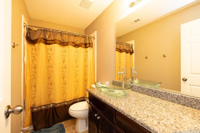 full bathroom featuring shower / bath combo, vanity, and toilet