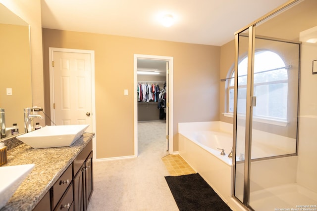 bathroom featuring plus walk in shower and vanity