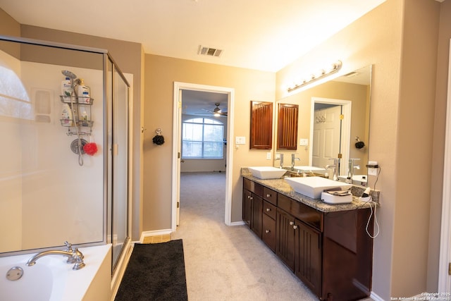 bathroom featuring ceiling fan, shower with separate bathtub, and vanity