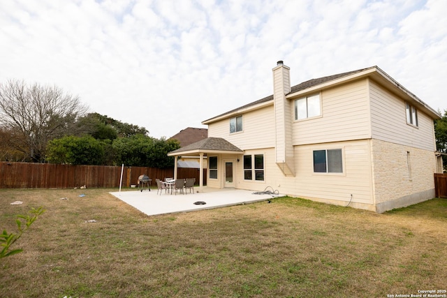 back of house with a yard and a patio area