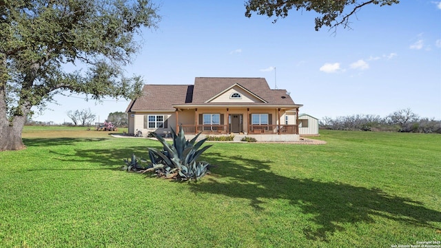 back of property featuring a yard, an outbuilding, and a porch