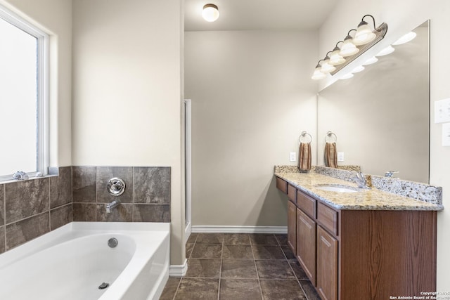 bathroom with tile patterned floors, vanity, and a bath