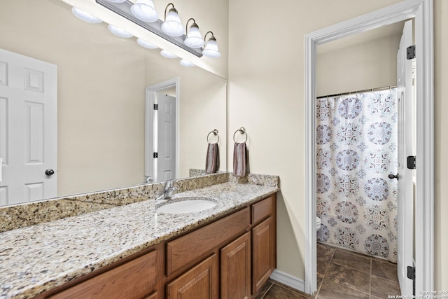 bathroom featuring vanity, toilet, and curtained shower