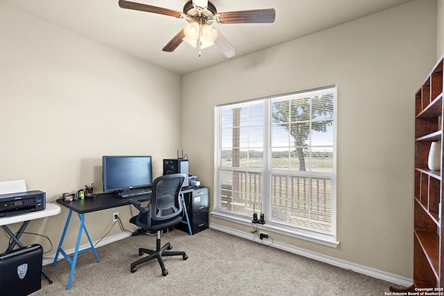 carpeted office space with ceiling fan