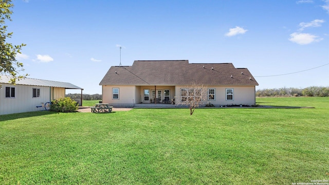 rear view of house with a patio area and a yard