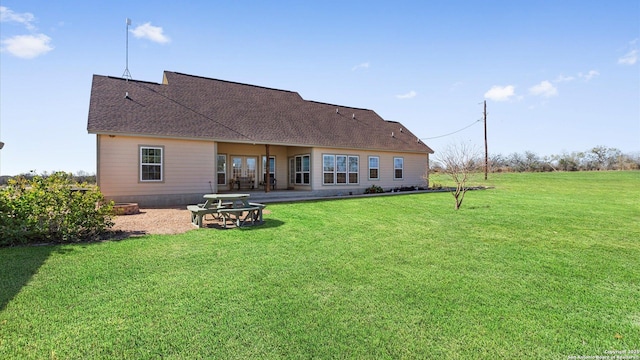 rear view of house with a yard and a patio