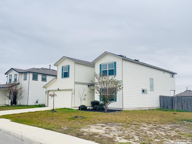 view of front of home with a garage and a front lawn